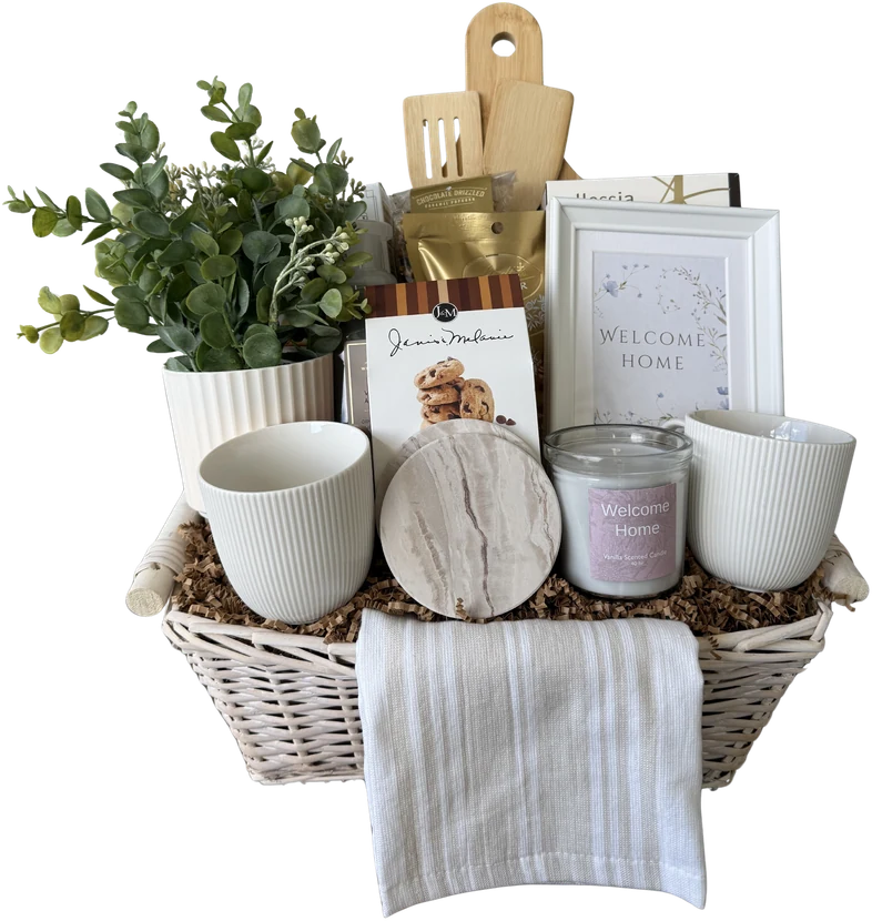Welcome Home gift basket with a charcuterie board, mugs, candle, plant and towel
